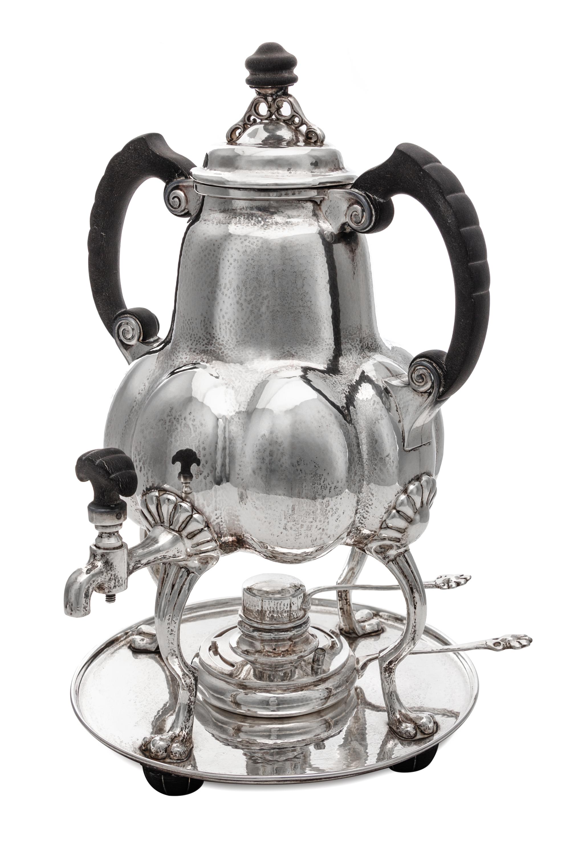A German Silver Kettle on Lampstand, Bremer Werkstatten fur Kunstgewerbliche Silberarbeiten, Early 20th Century, having an ebonized fin