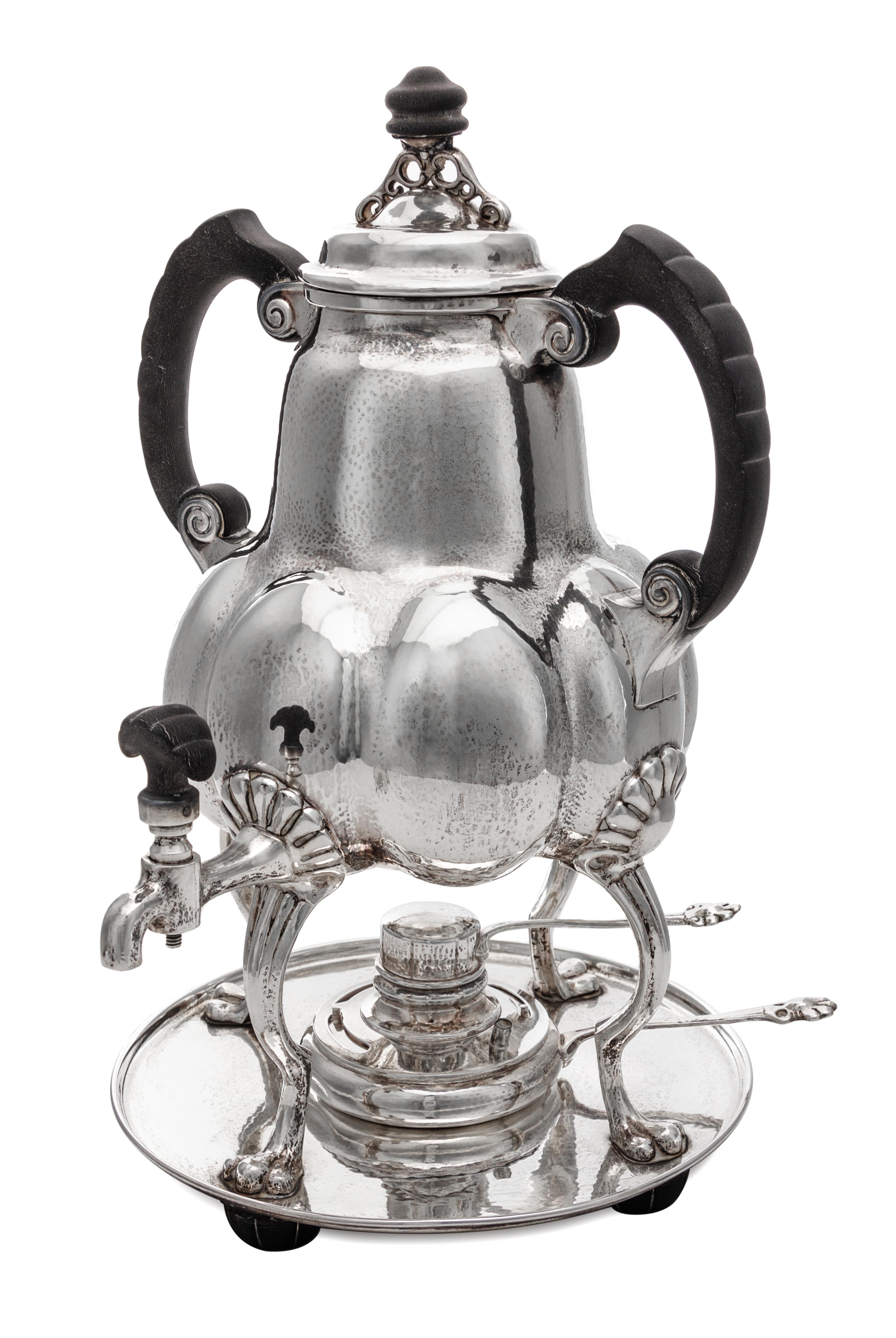 A German Silver Kettle on Lampstand, Bremer Werkstatten fur Kunstgewerbliche Silberarbeiten, Early 20th Century, having an ebonized fin