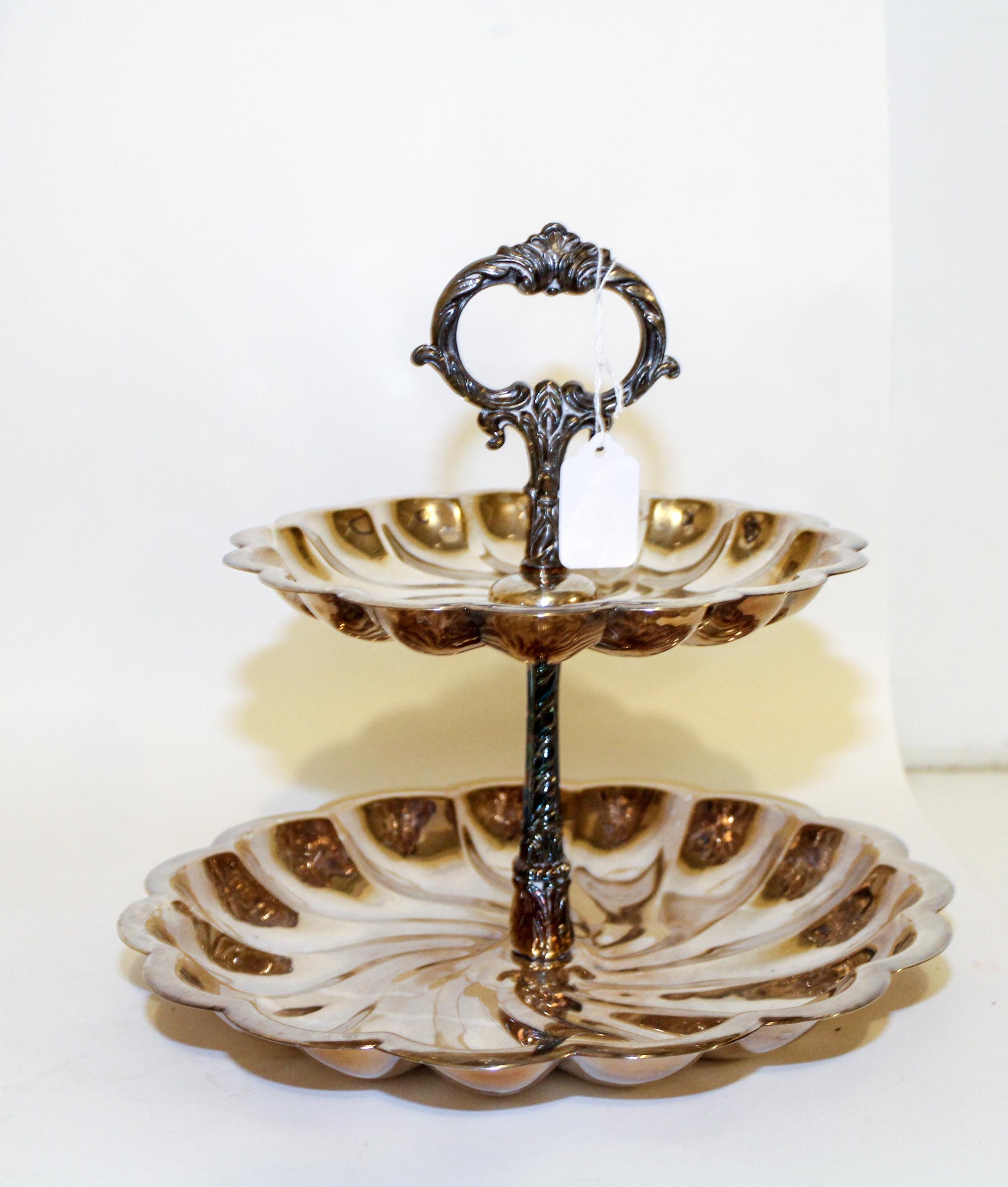 An American Silver-Plate Two-Tiered Cake Stand, F.B. Rogers Silver Co., Shelburne Falls, MA, each tier having an undulating rim with a
