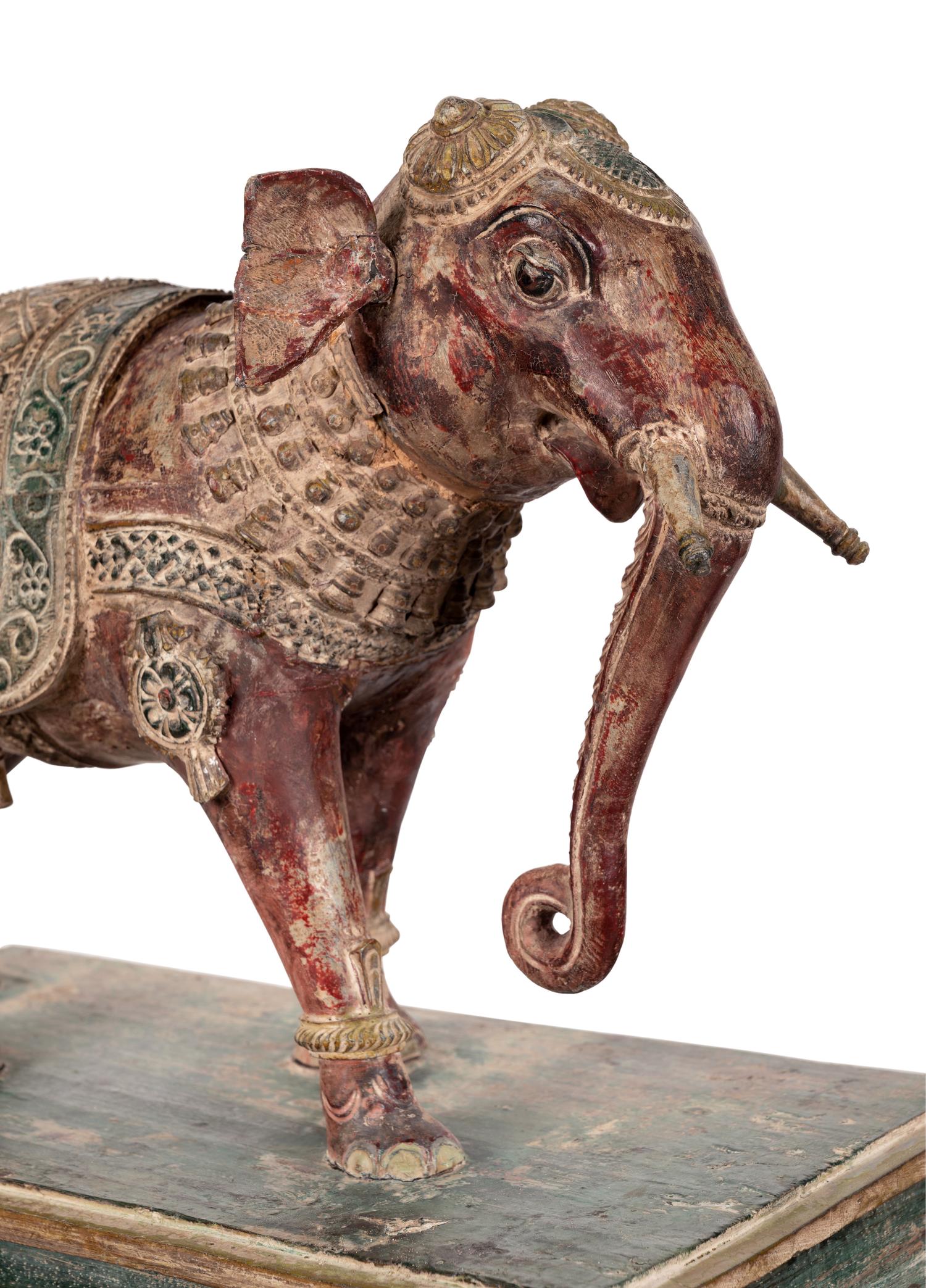 An Indian Carved Wood Model of an Elephant in a Walnut and Glass Vitrine