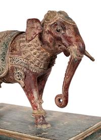 An Indian Carved Wood Model of an Elephant in a Walnut and Glass Vitrine