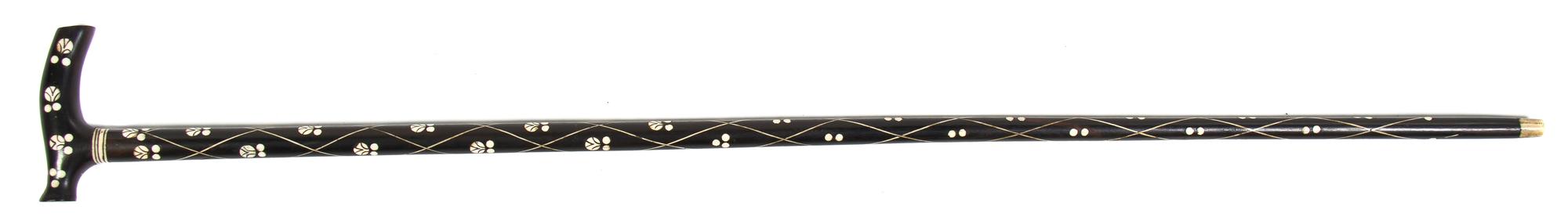 An Ivory Inlaid Ebony Cane, Height overall 37 inches, width of handle 4 3/8 inches.