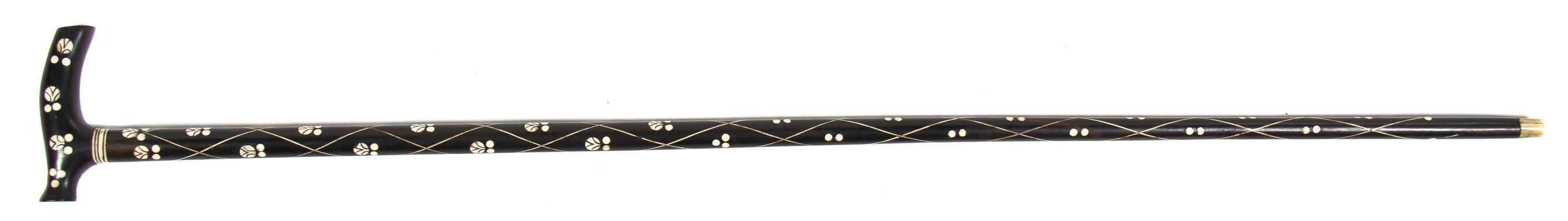 An Ivory Inlaid Ebony Cane, Height overall 37 inches, width of handle 4 3/8 inches.