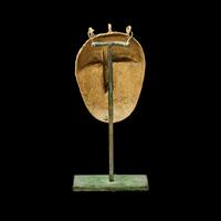 A Lagoons Region Gilt-Brass Mask Pendant
