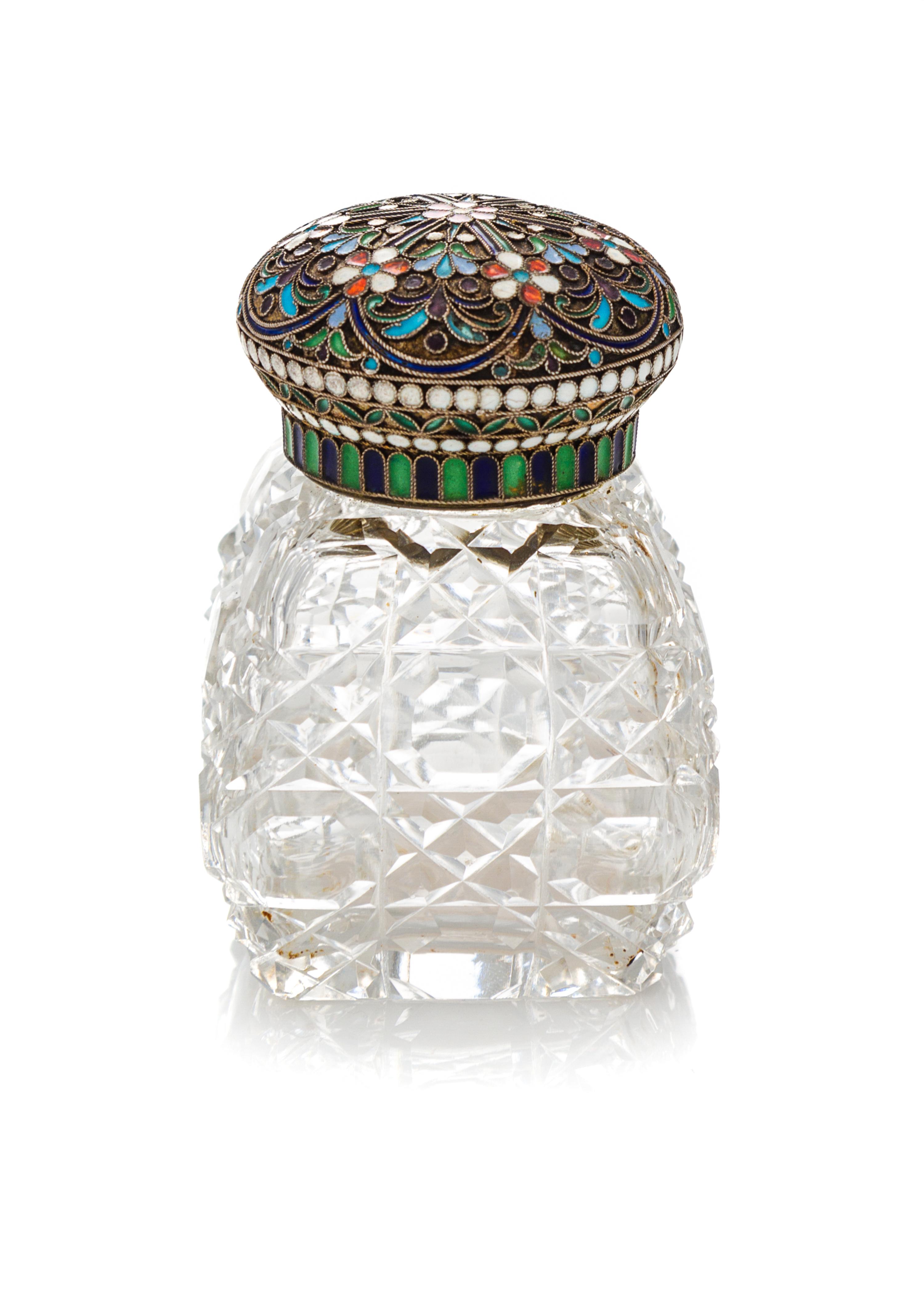 A Russian Enameled Silver and Cut Glass Scent Bottle, 19th Century, having a circular lid decorated with stylized floral decoration sur