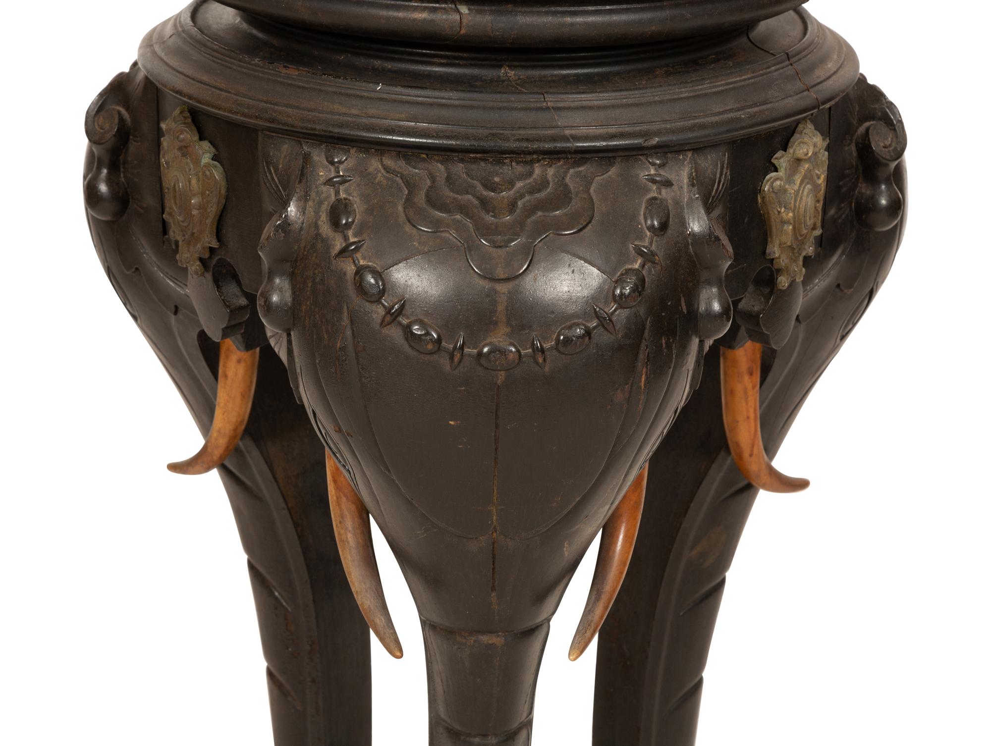 An Anglo-Indian Carved Ebonized Elephant Table