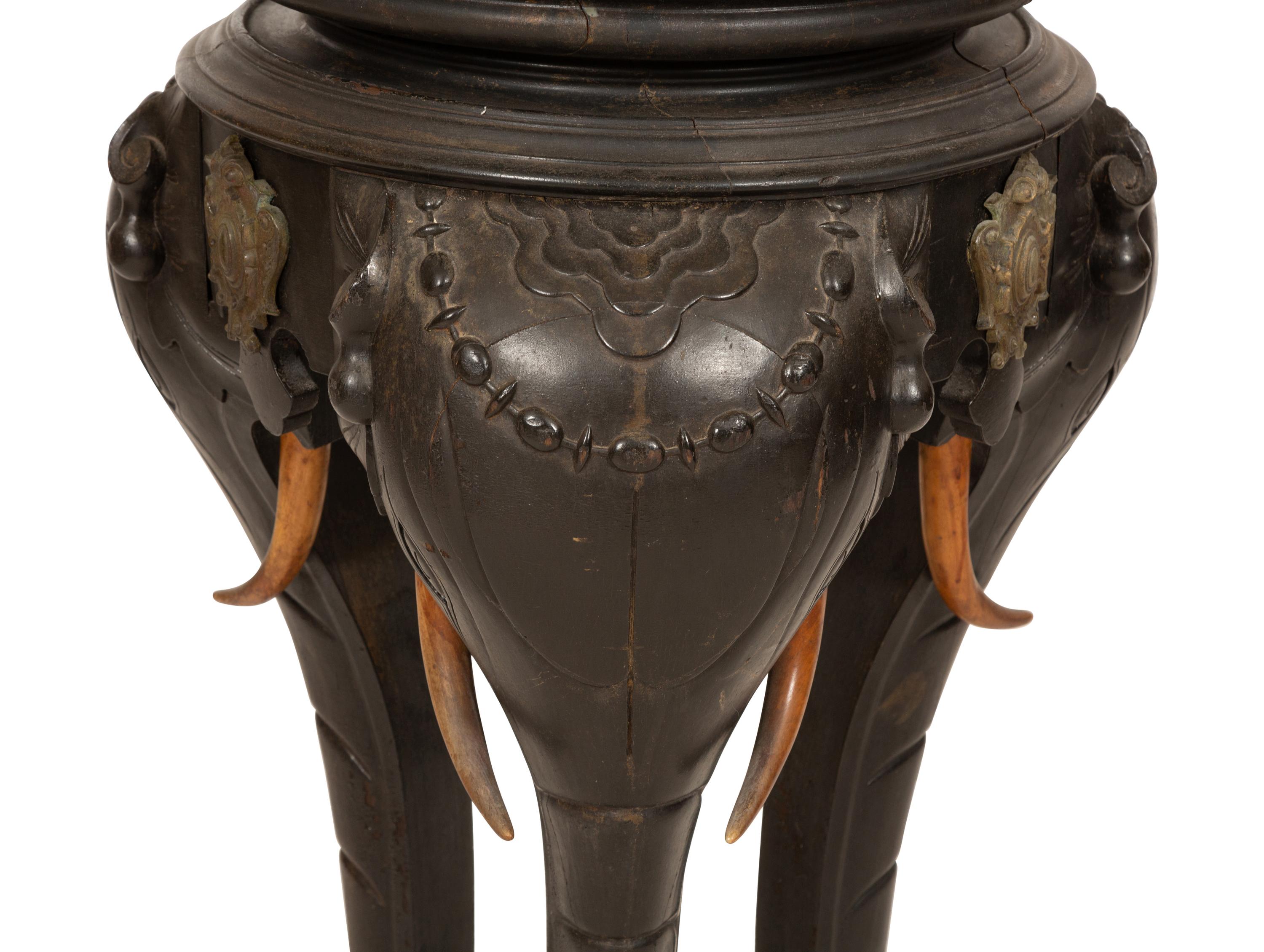 An Anglo-Indian Carved Ebonized Elephant Table