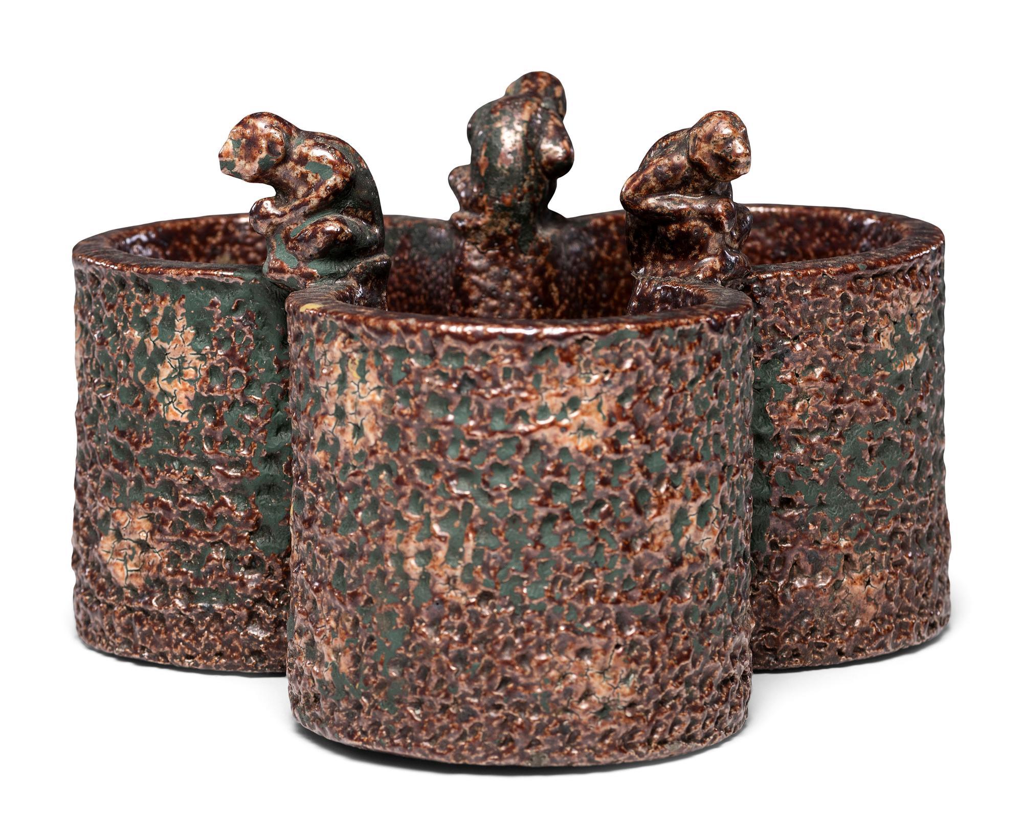A Glazed Sewer Tile Trefoil Vase or Planter with Seated Monkeys