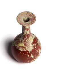 A Hellenistic or Roman Opaque Dark Red Glass Bottle
