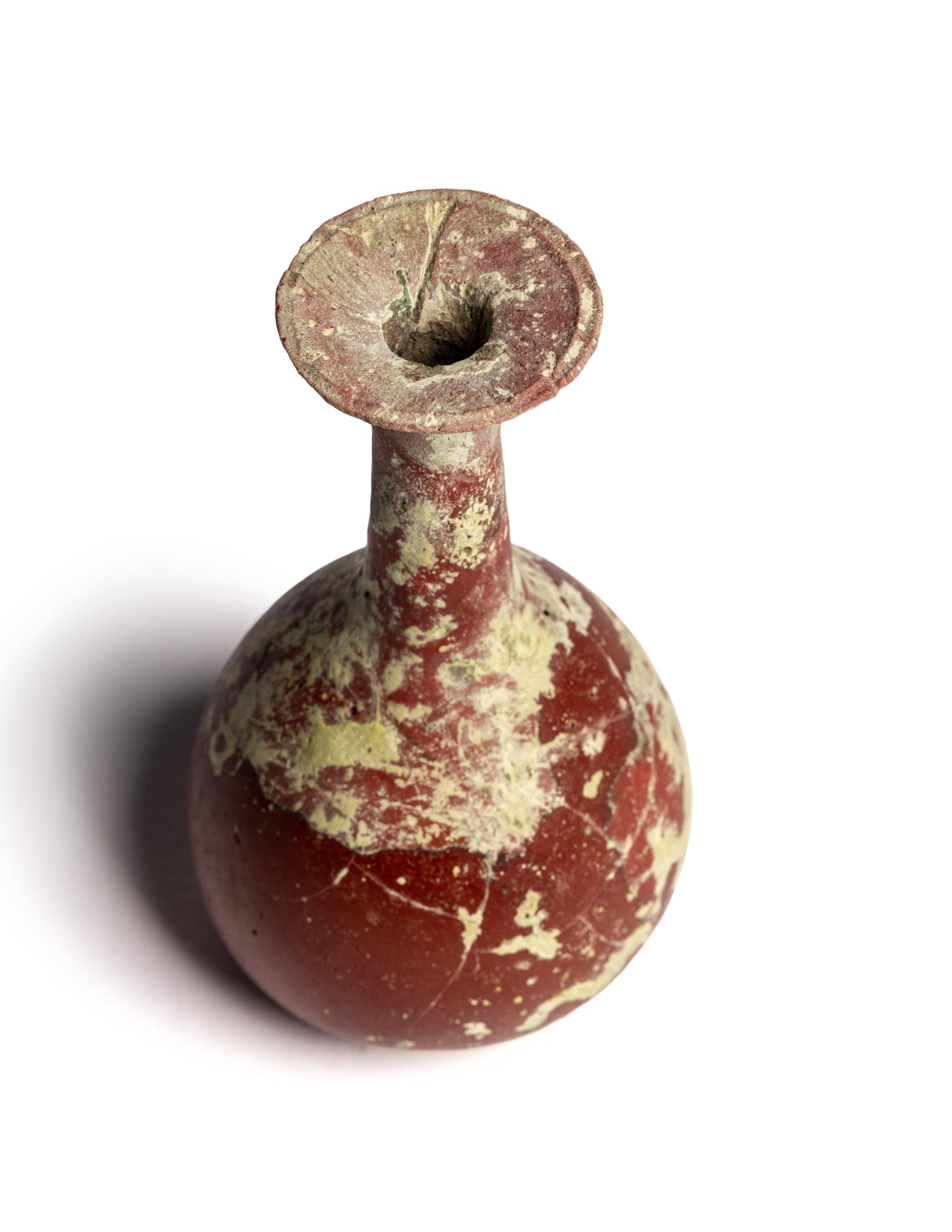 A Hellenistic or Roman Opaque Dark Red Glass Bottle