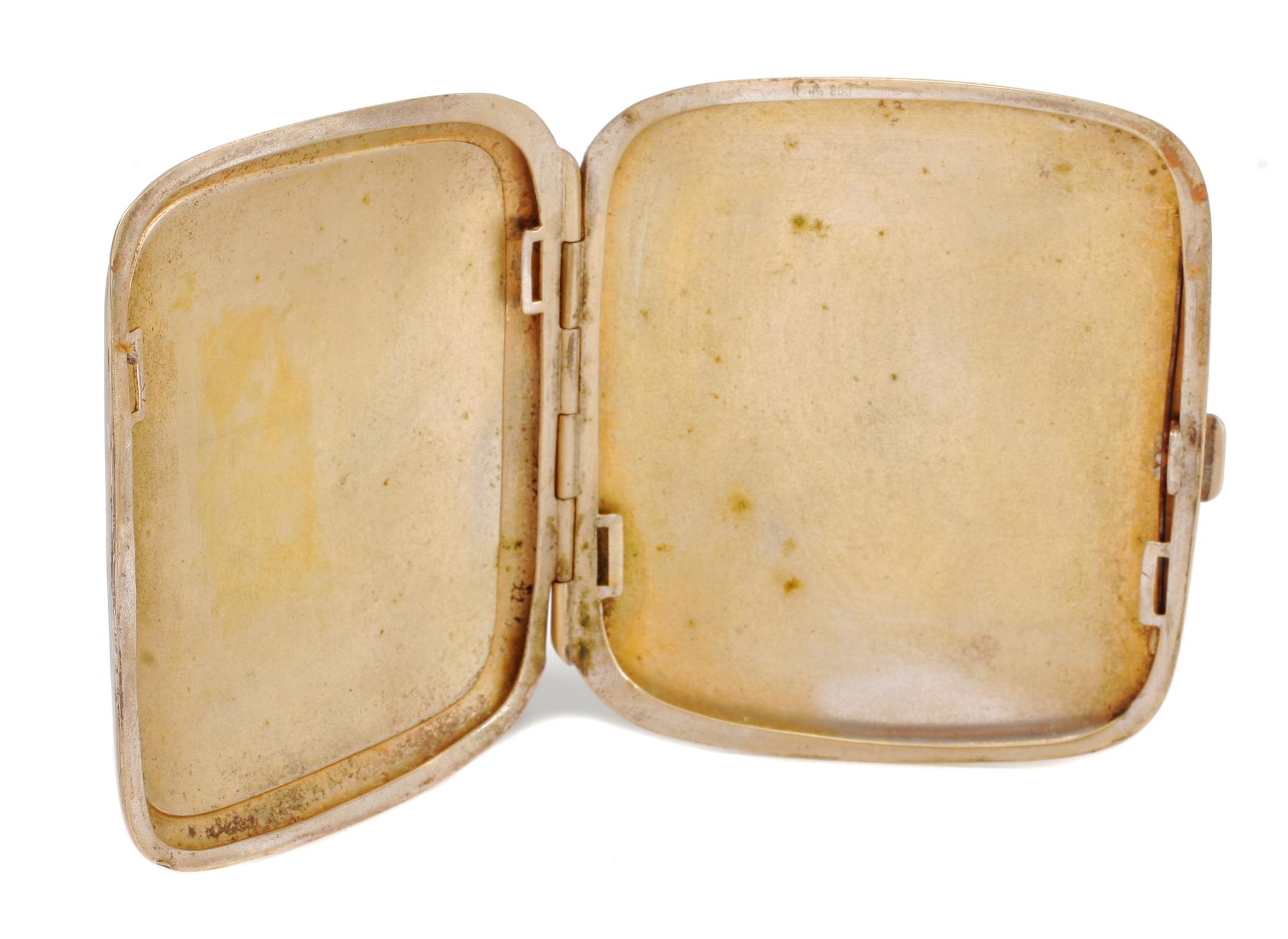 A German Enameled Silver Cigarette Case, Late 19th/Early 20th Century, the lid decorated with a female figure posing in a state of undr