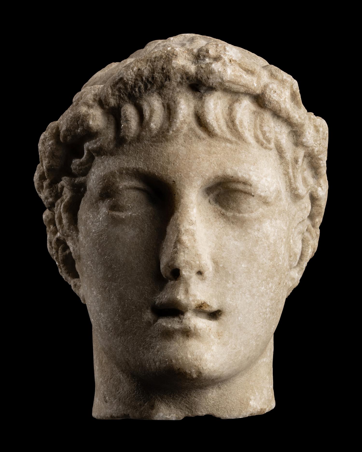 A Roman Marble Head of a Youth with Laurel Wreath