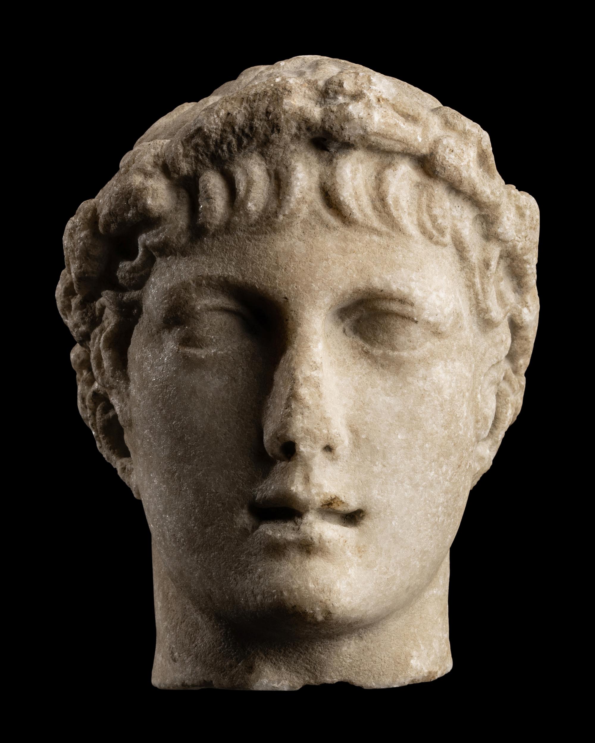 A Roman Marble Head of a Youth with Laurel Wreath