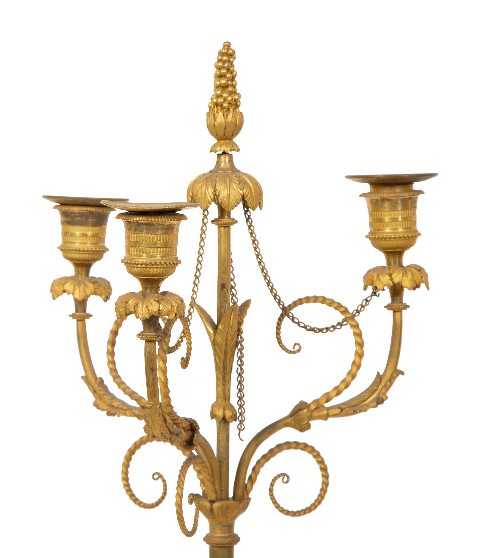 A Pair of French Patinated and Gilt Bronze Figural Three-Light Candelabra