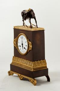 An Empire Style Gilt and Patinated Bronze Mantel Clock