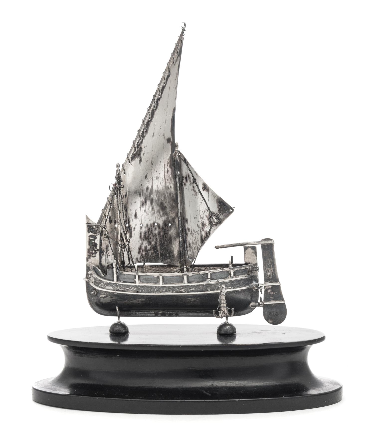 A Continental Silver Nef, Likely Dutch, Maker's Mark F.P., Late 19th/Early 20th Century, mounted to a wood base.