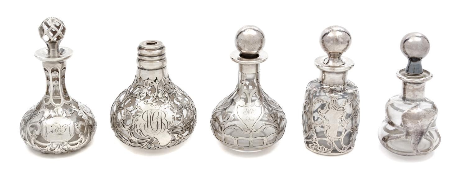 A Group of Five Silver Overlay Glass Perfume Bottles Height of tallest 3 1/2 inches.