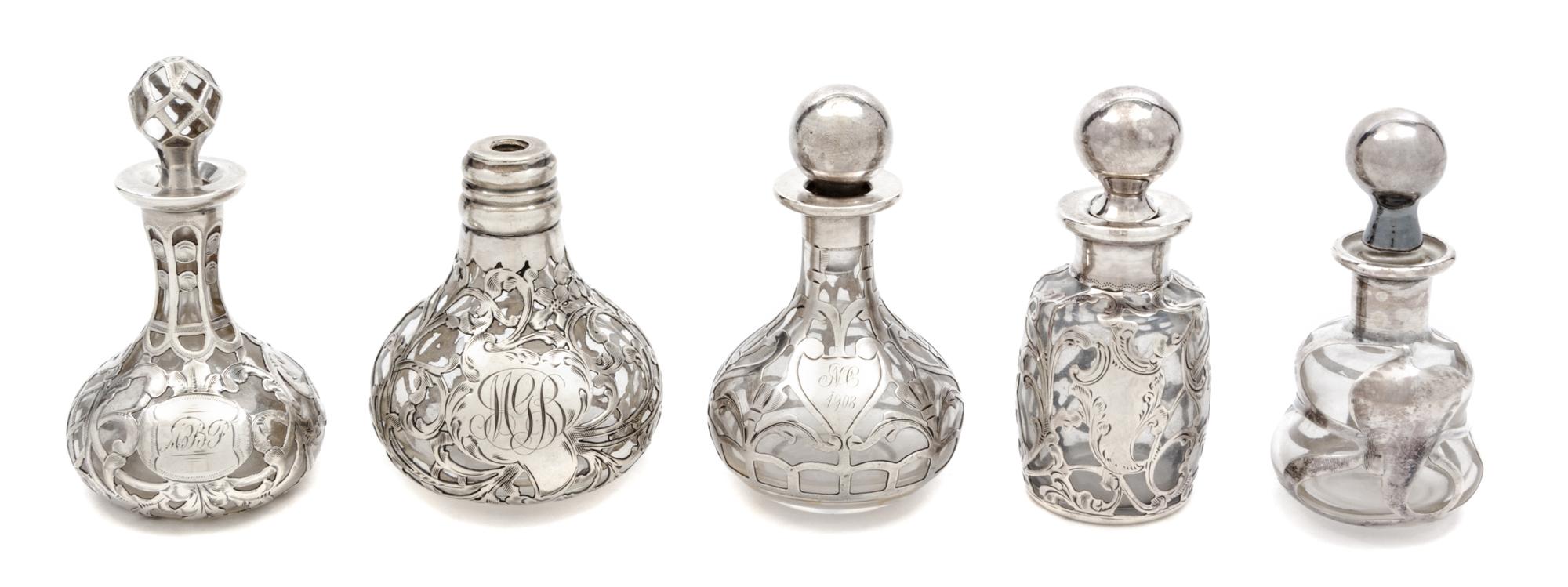A Group of Five Silver Overlay Glass Perfume Bottles Height of tallest 3 1/2 inches.