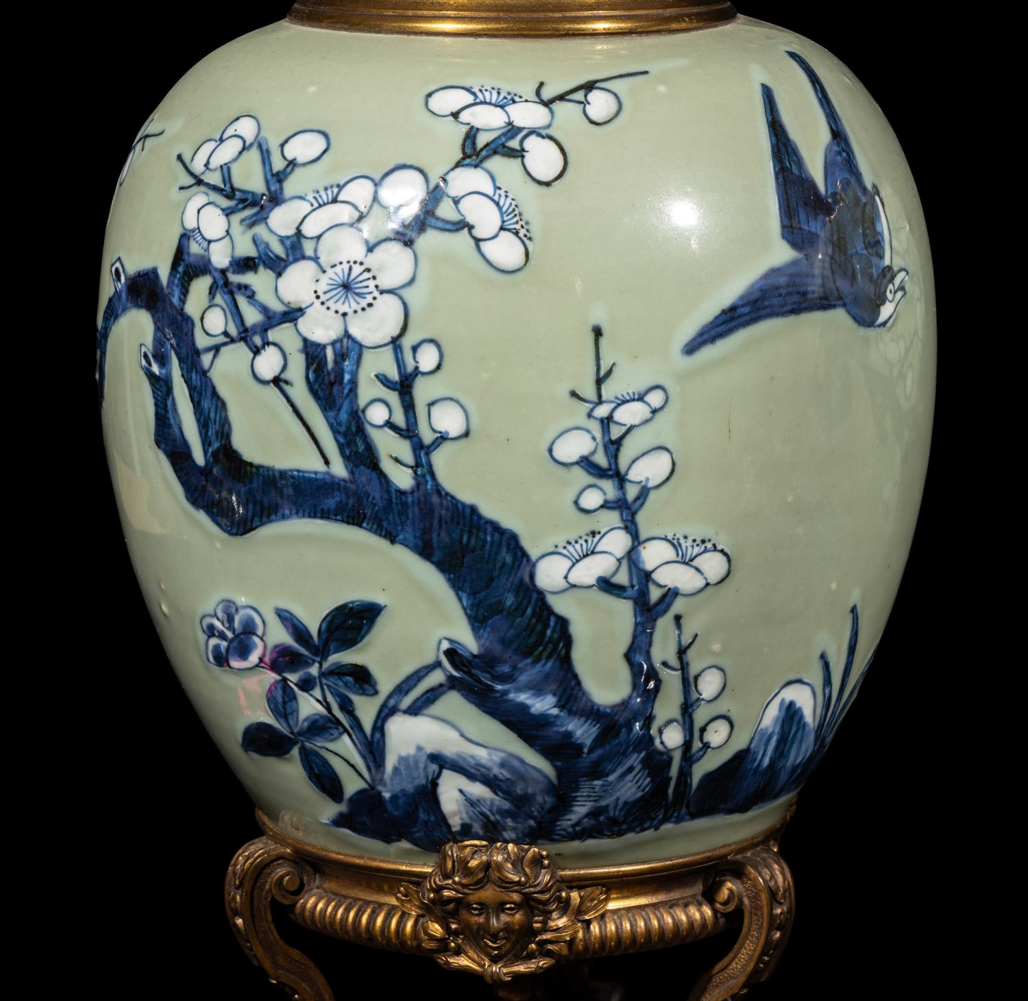 A Pair of Chinese Celadon Ground Blue and White Porcelain Jars with Later Ormolu Mounts, Porcelain: Kangxi Period, Mounts: Late 19th/Early 20th Century 銅鎏金鑲清康熙豆青地青花喜上眉梢圖罐一對