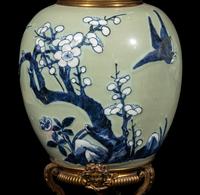 A Pair of Chinese Celadon Ground Blue and White Porcelain Jars with Later Ormolu Mounts, Porcelain: Kangxi Period, Mounts: Late 19th/Early 20th Century 銅鎏金鑲清康熙豆青地青花喜上眉梢圖罐一對