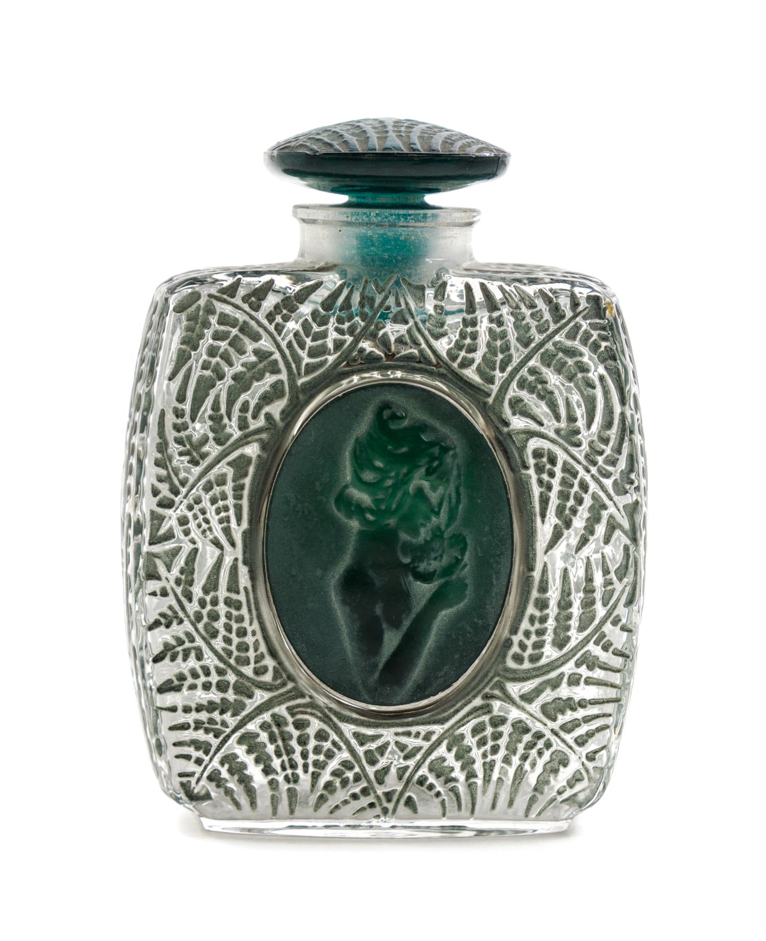 A Rene Lalique Molded Glass Perfume Bottle Height 3 5/8 inches.