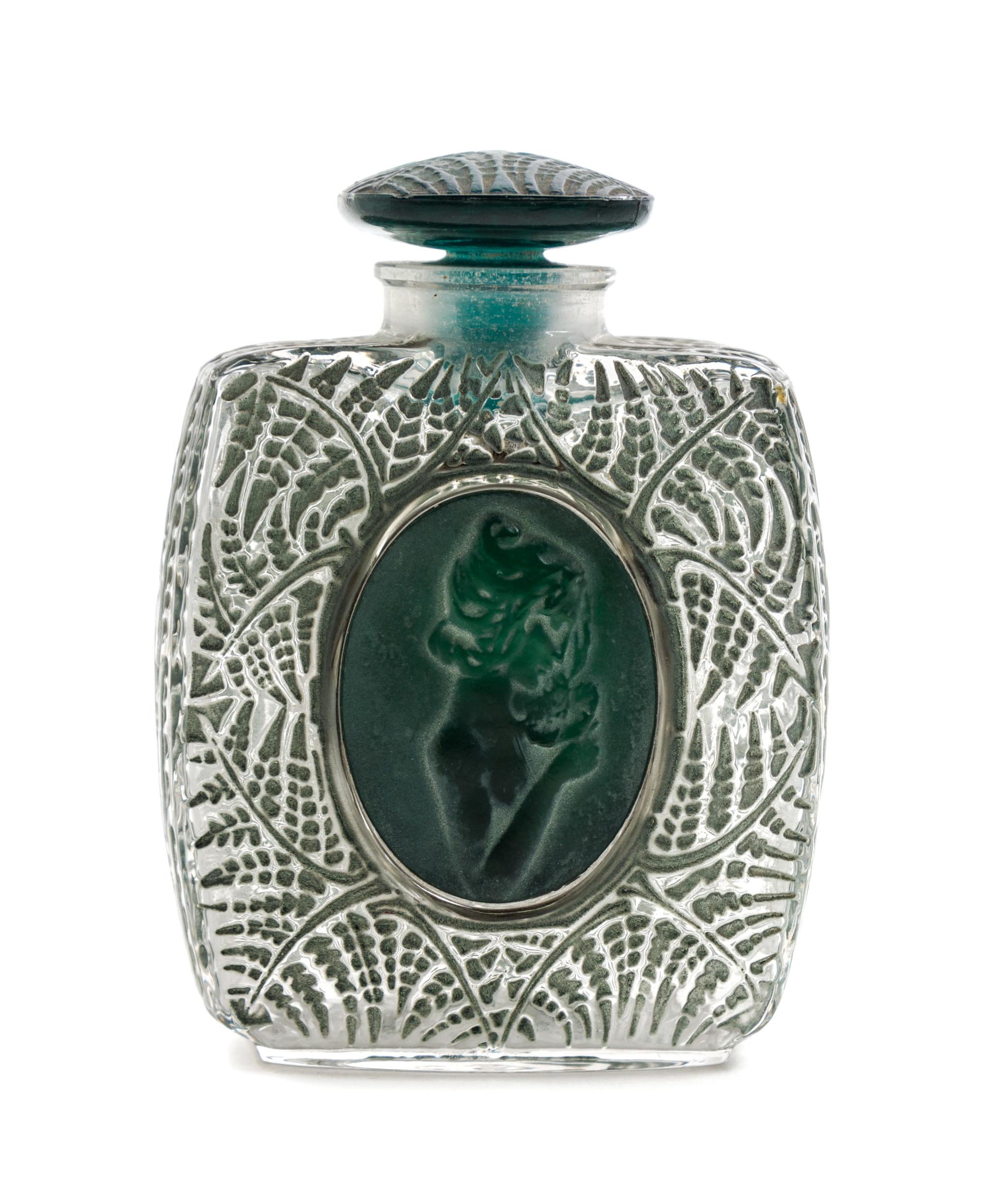 A Rene Lalique Molded Glass Perfume Bottle Height 3 5/8 inches.
