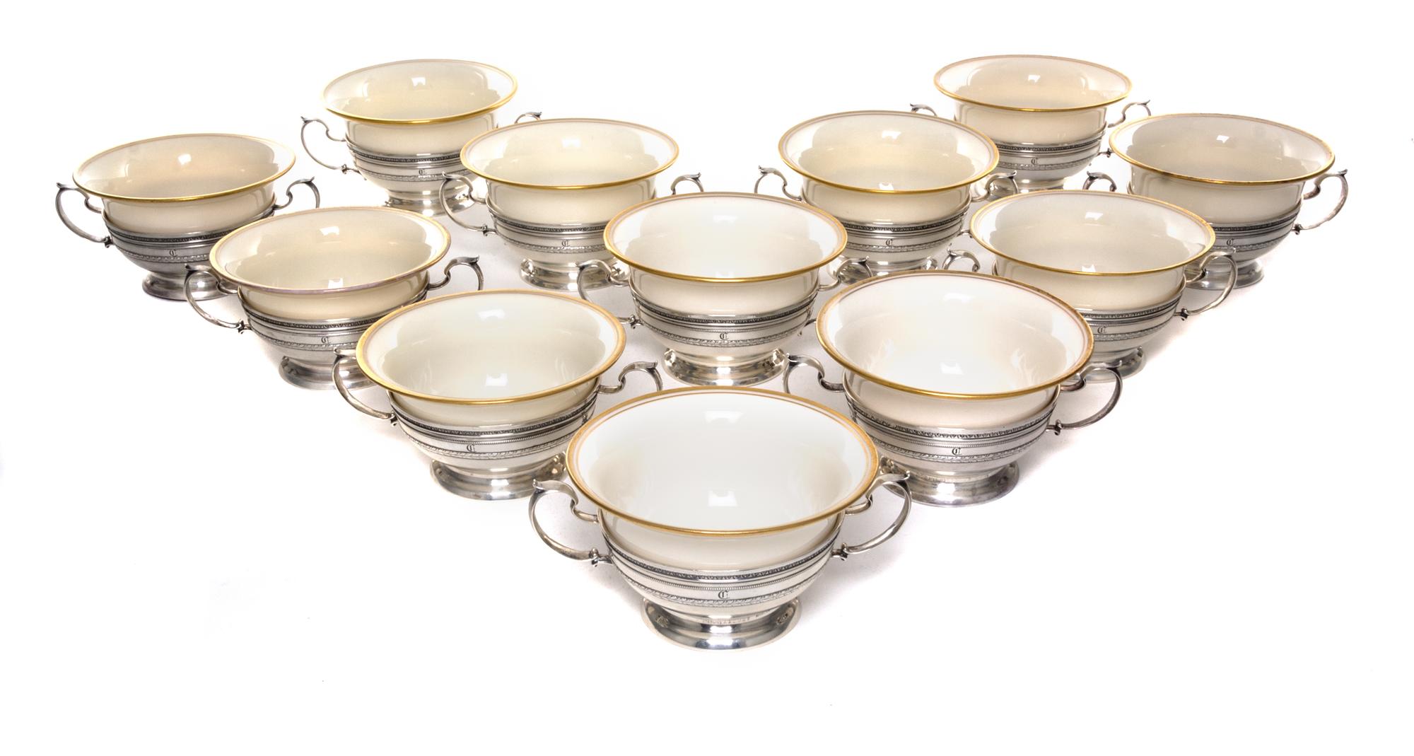 A Set of Twelve American Silver Soups, Gorham Mfg. Co., Providence, RI, each of double handled form with gilt rimmed Lenox porcelain li