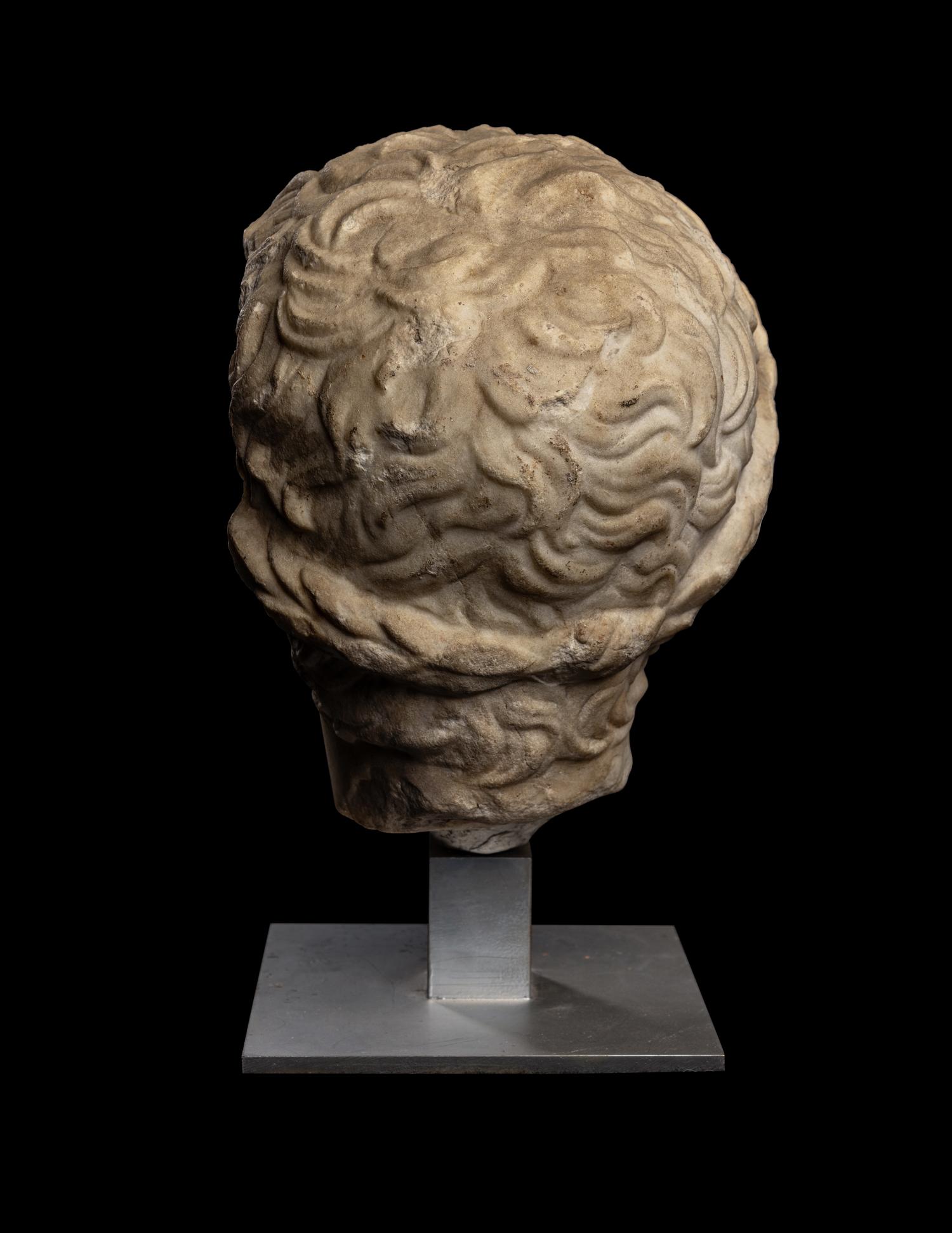 A Roman Marble Head of a Youth Wearing a Laurel Wreath