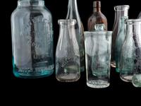 Sixteen Glass Advertising Bottles