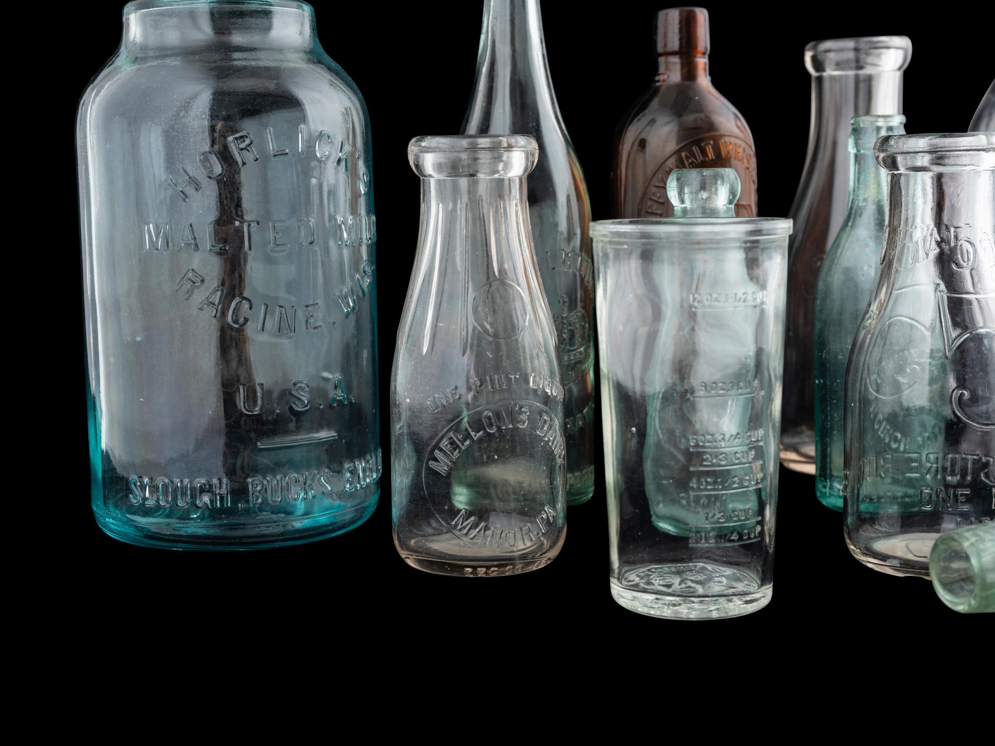 Sixteen Glass Advertising Bottles