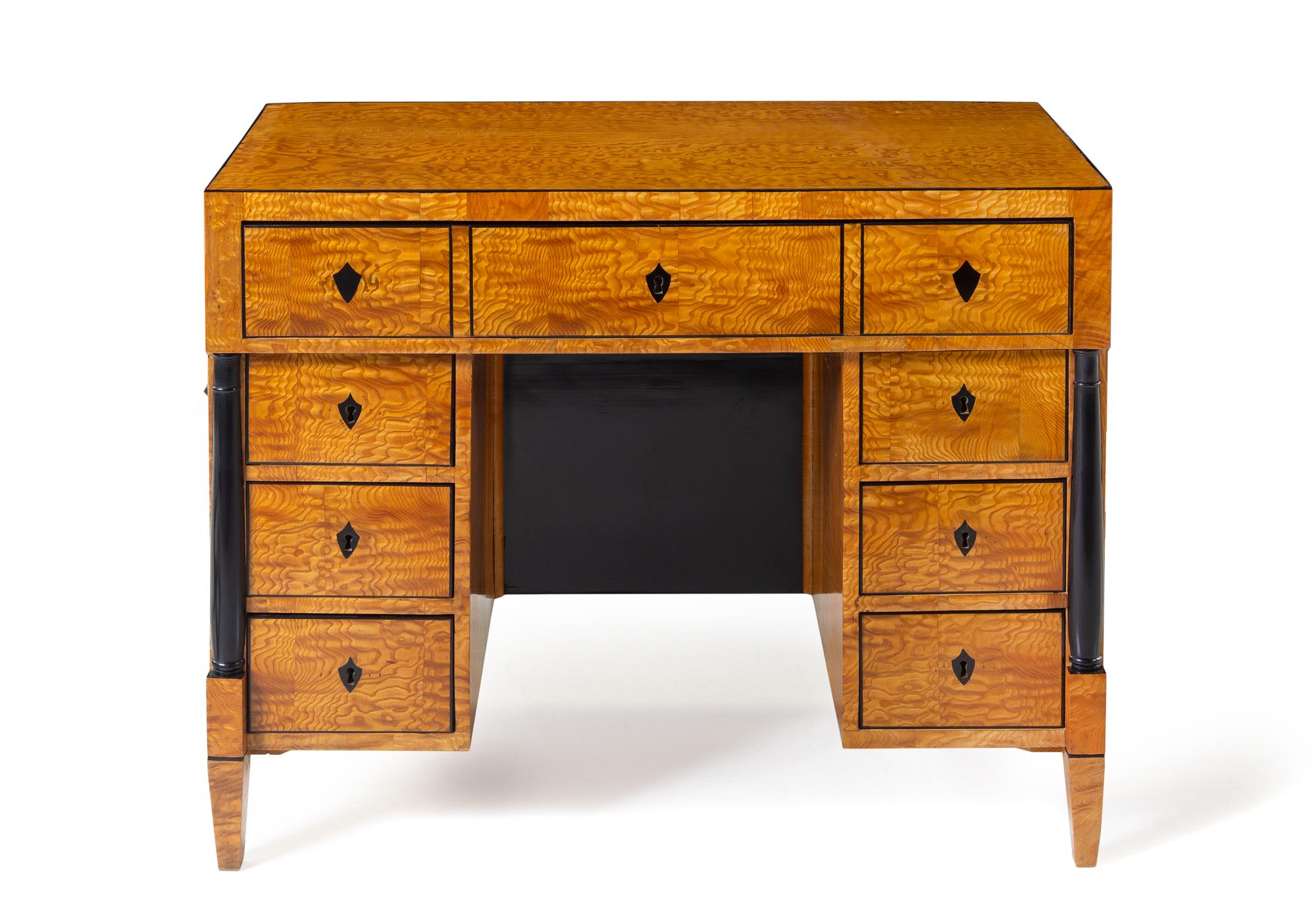 A Biedermeier Birch Kneehole Desk