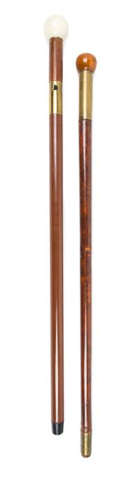 Two Brass Mounted Canes Length of longer 36 1/2 inches.
