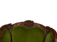 A Louis XV Style Carved Fruitwood Bergère à Oreilles