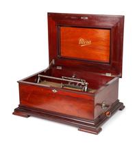A Mira 15 1/2 Inch Disc Music Box and Seventeen Discs