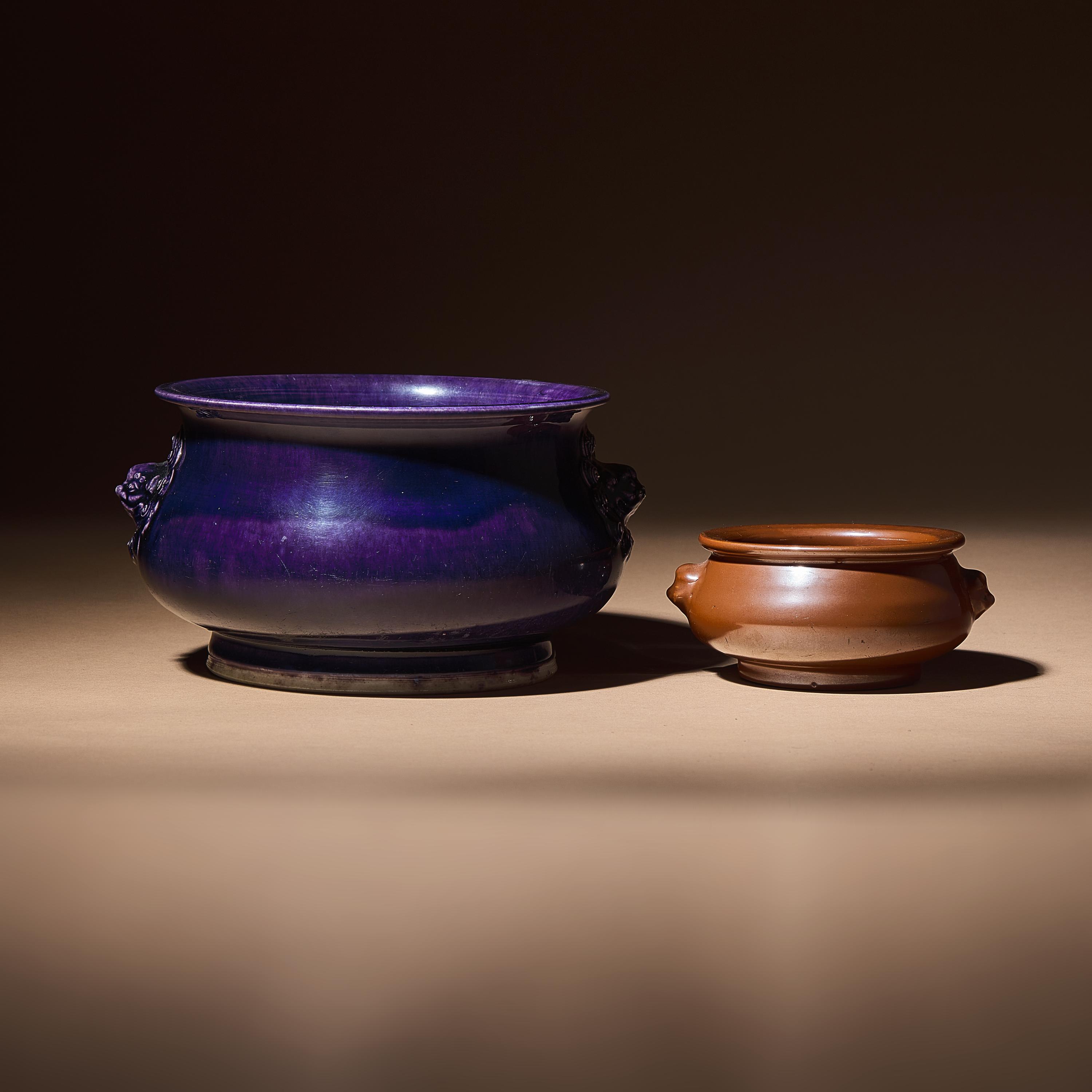 Two Chinese Monochrome Glazed Porcelain Censers, 17th-18th Century — 清早中期 紫金釉及藍釉獅耳爐兩具