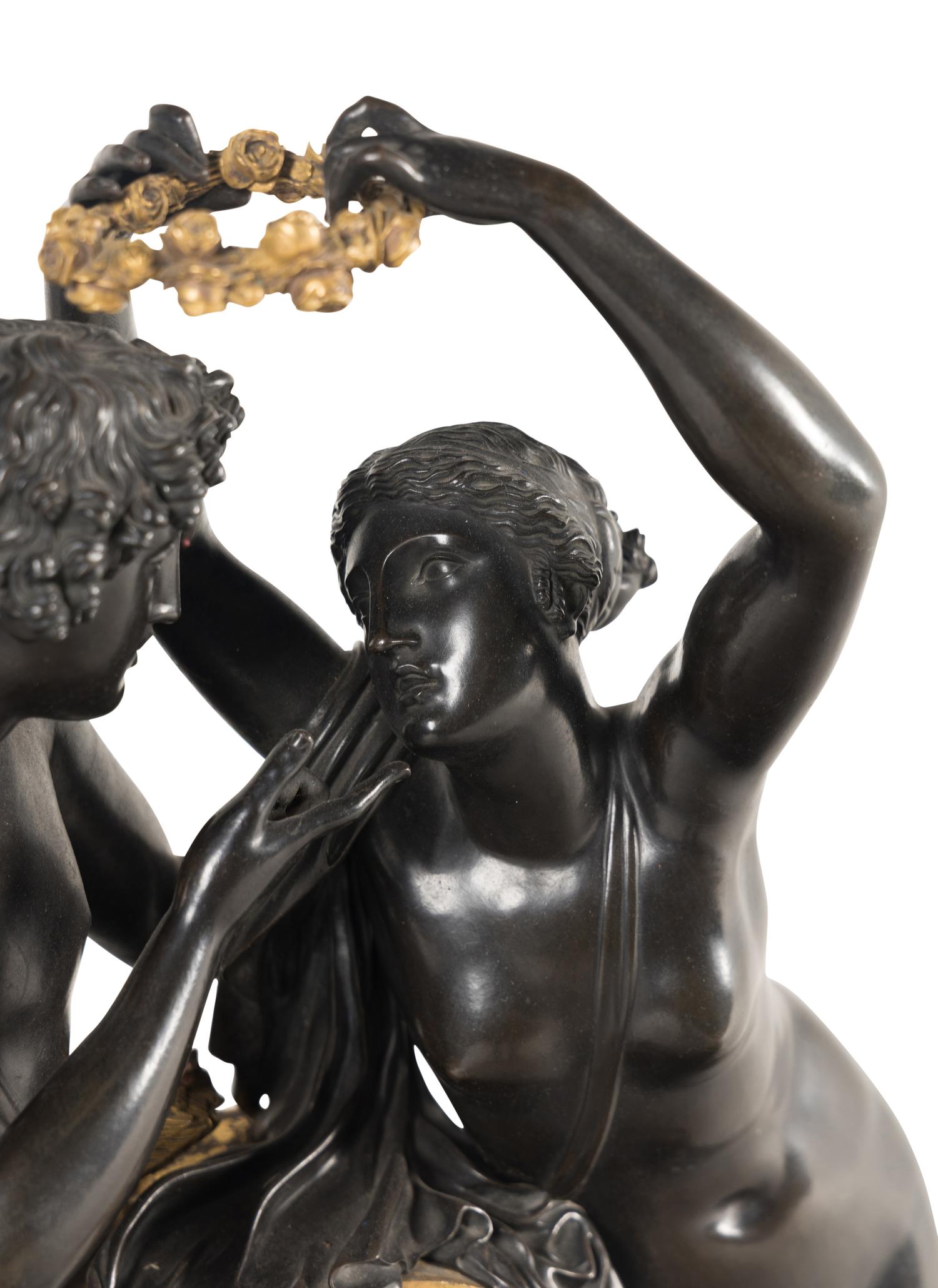 A French Parcel Gilt and Patinated Bronze Figural Mantel Clock