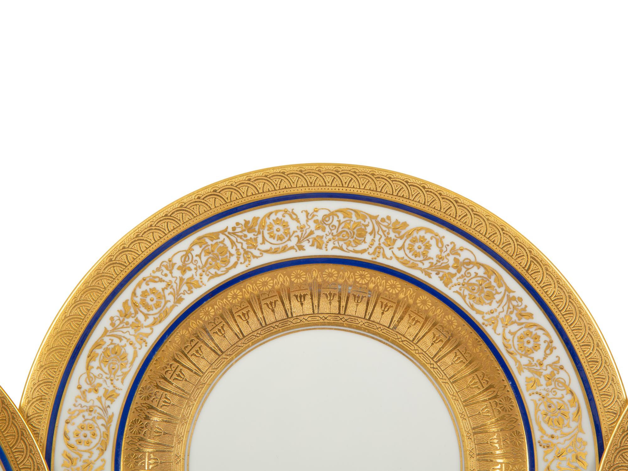 A Set of Twelve Hutschenreuther Gilt Decorated White and Cobalt GLazed Porcelain Dinner Plates