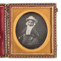 [AFRICAN AMERICANA - EARLY PHOTOGRAPHY]. Sixth plate daguerreotype portrait of a nicely-dressed child, with the hand of an African American subject visibly grasping the child's hand.