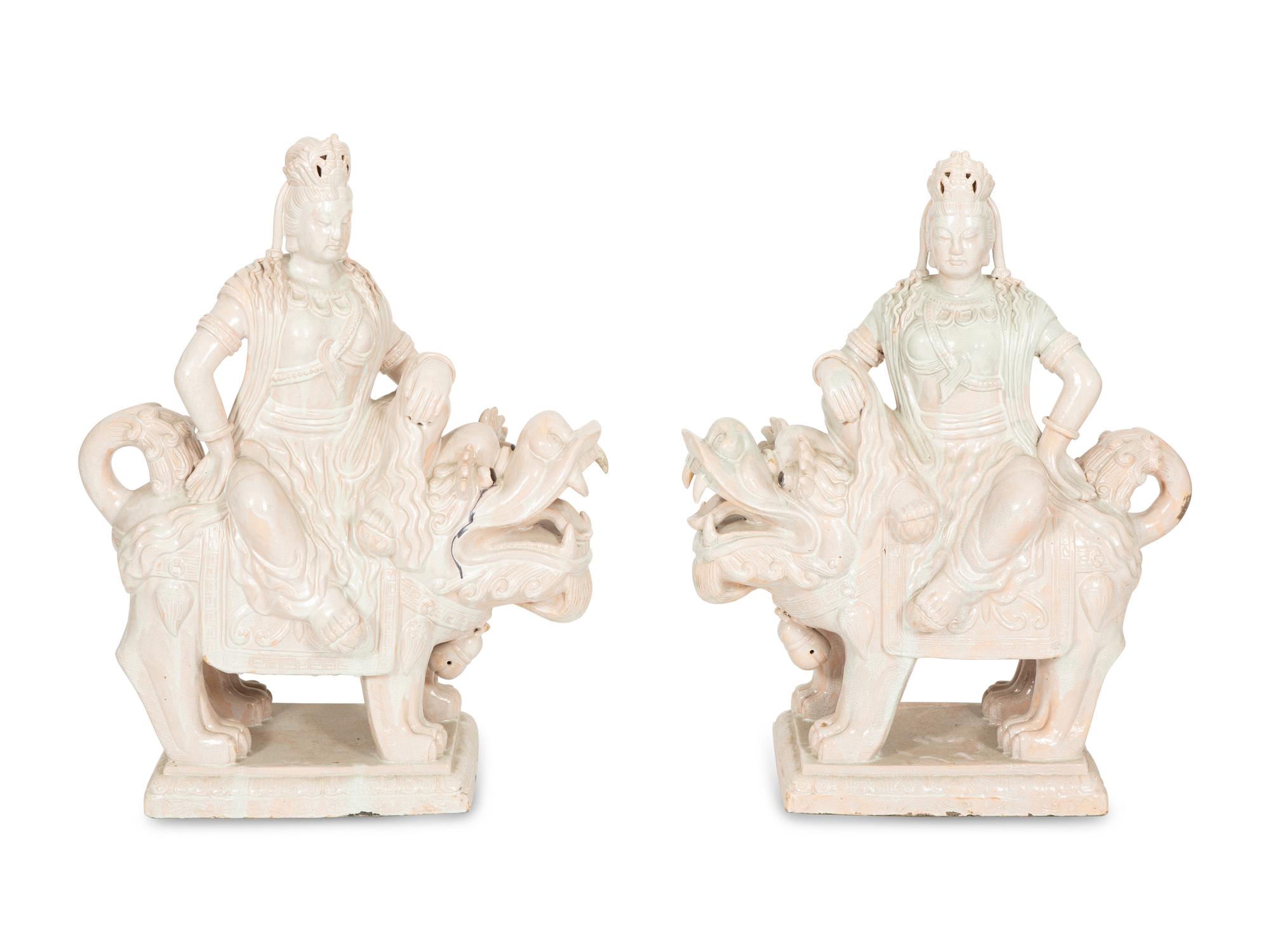 A Pair of Chinese Glazed Ceramic Figures of Guan Yin Atop a Foo Dog