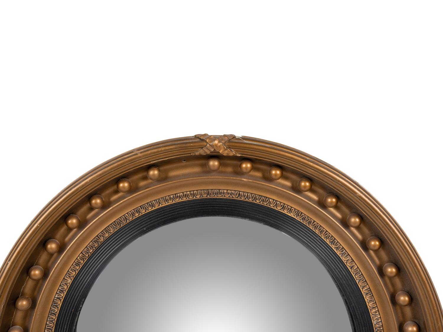 A Regency Giltwood and Ebonized Convex Mirror