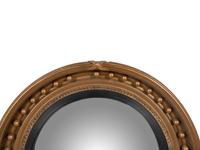A Regency Giltwood and Ebonized Convex Mirror