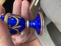 A 14 Karat Vari-Color Gold, Guilloché Enamel, Diamond, and Cabochon Jewel-Mounted Egg-Form Perfume and a Related Guilloché Enamel, 14 Karat Vari-Color Gold, Diamond, and Cabochon-Mounted Surprise Egg