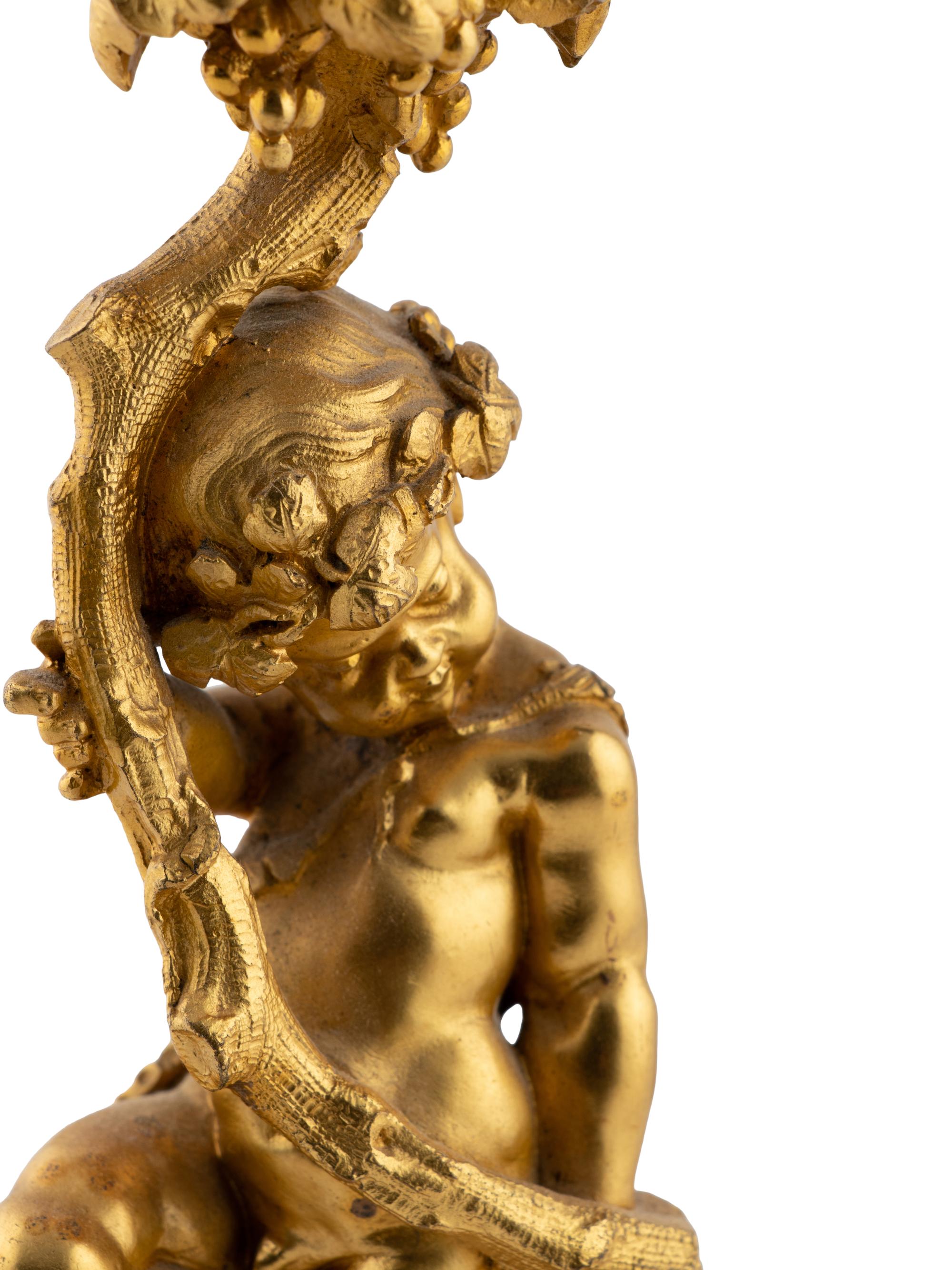 A Pair of French Gilt Bronze and Bourdin Porcelain Figural Candlesticks