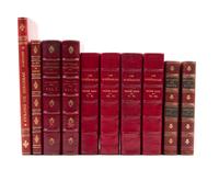 (BINDINGS) A group of 11 books bound in shades of red leather.