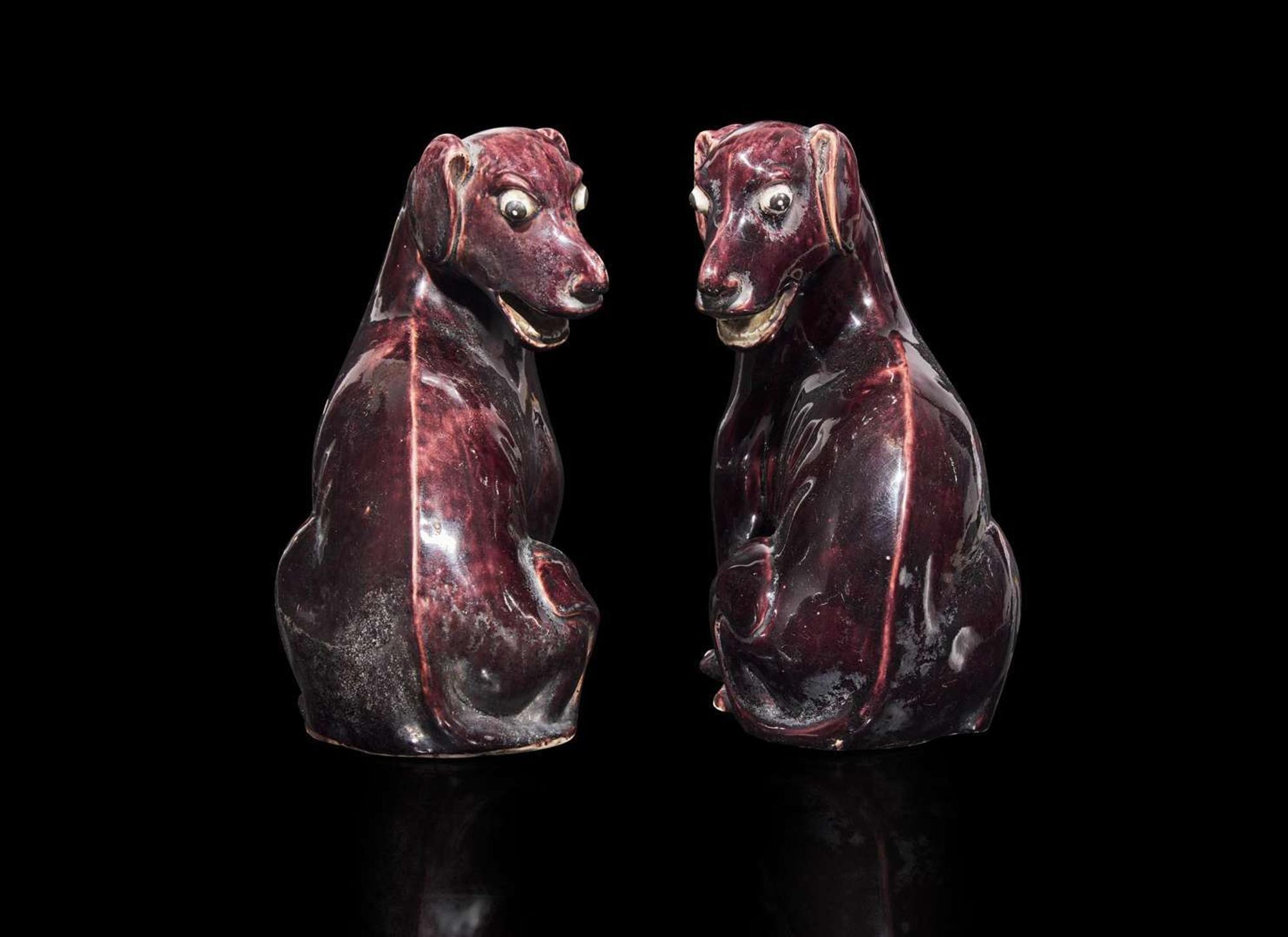 A pair of Chinese export aubergine-glazed porcelain seated dogs, 茄紫釉小狗一對