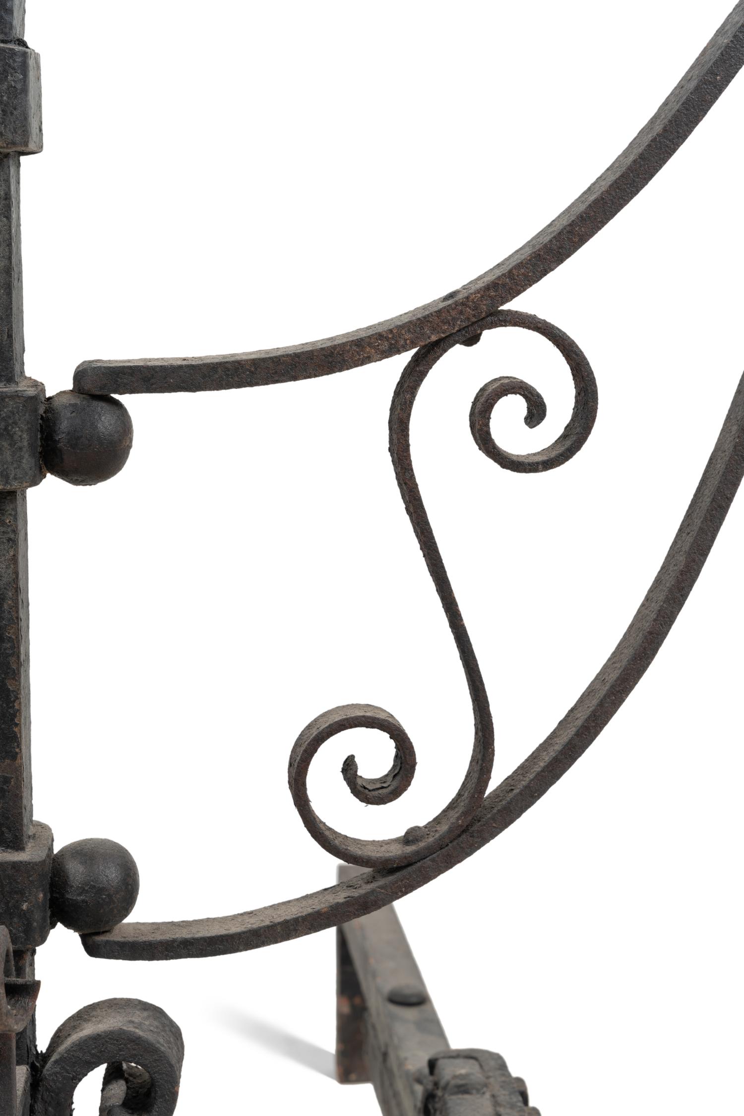 A Pair of Continental Iron Andirons with Posset Cup Holders