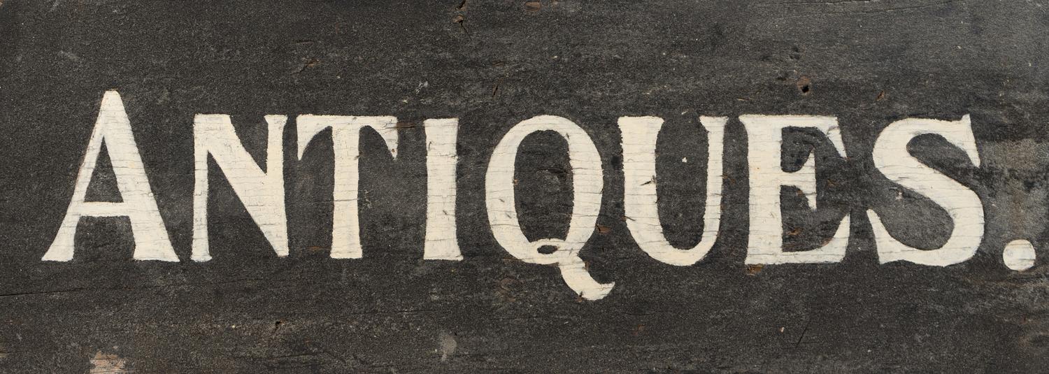 A Painted Wood Antiques Seller's Trade Sign