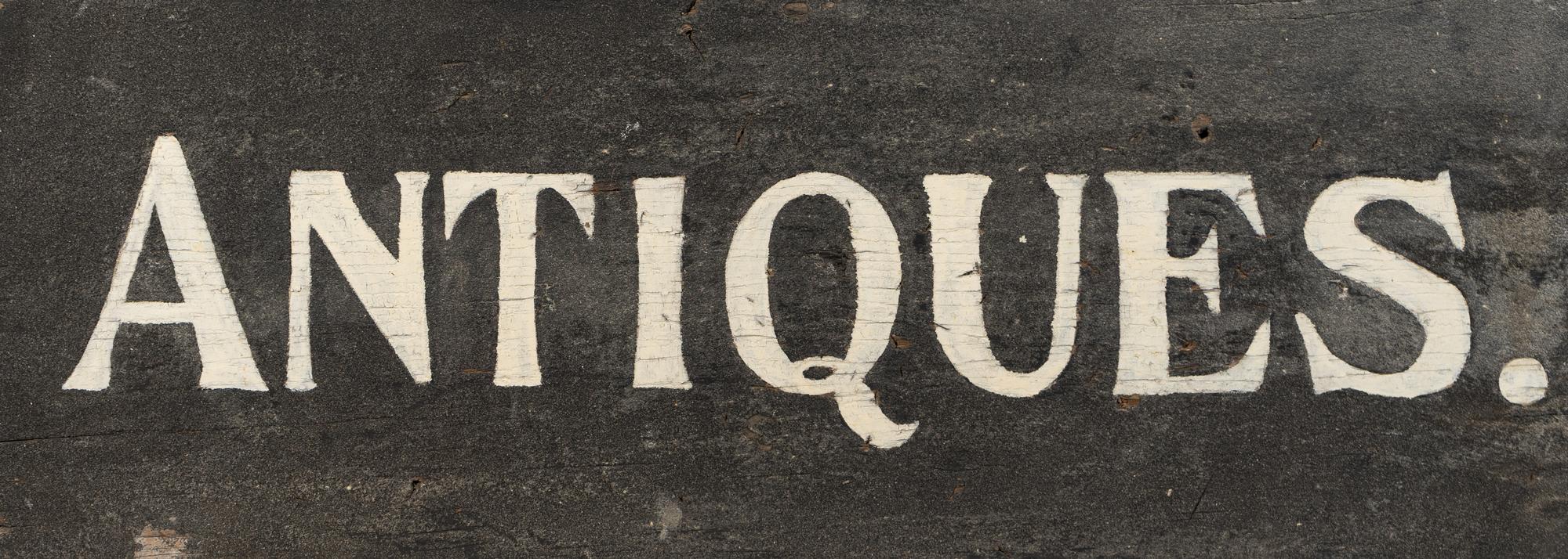 A Painted Wood Antiques Seller's Trade Sign