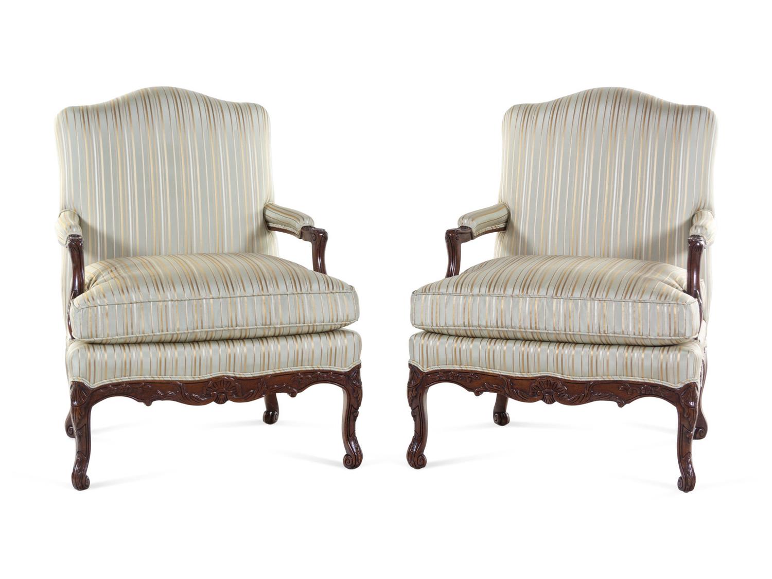 A Pair of Louis XV Style Carved Walnut Fauteuils