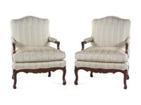 A Pair of Louis XV Style Carved Walnut Fauteuils